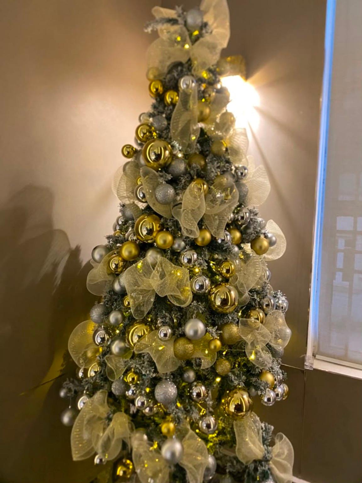 Gold and neutral ornaments on a Christmas tree