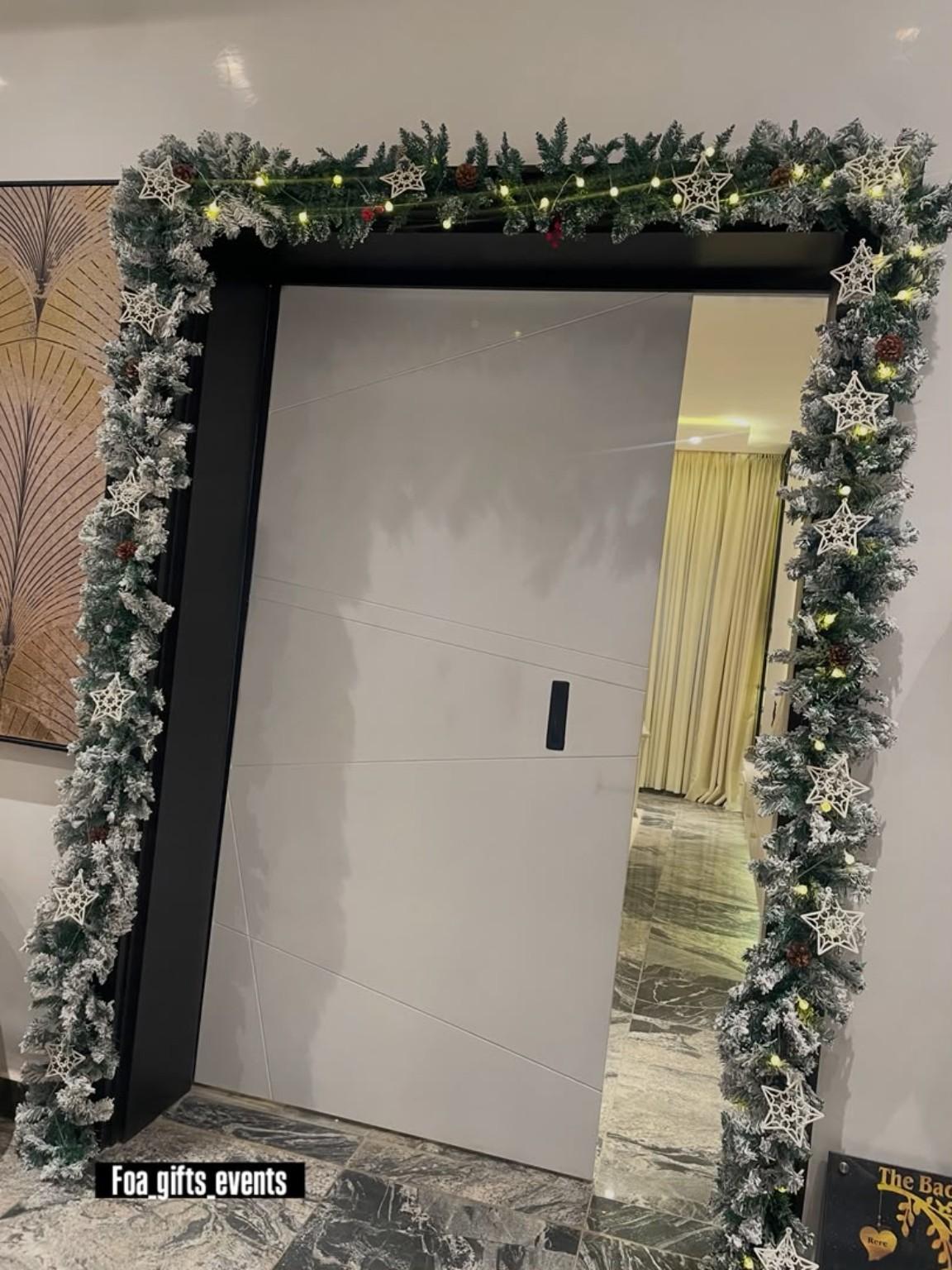 Doorway framed by a neutral Christmas garland
