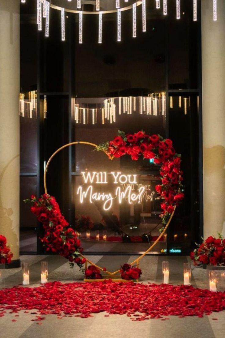 Red and gold proposal setup with roses and candles in Abuja by FOA Gifts
