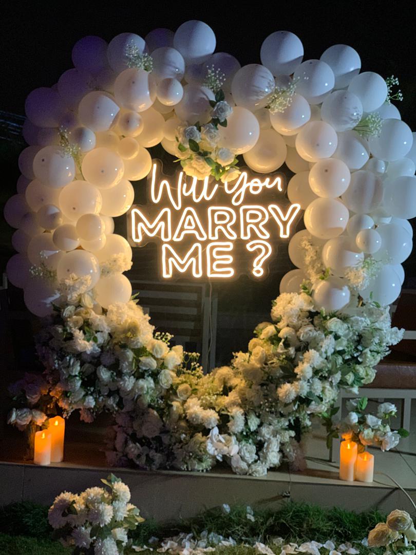 Will You Marry Me surprise proposal setup with white balloons and candles in Abuja Nigeria by FOA_gifts